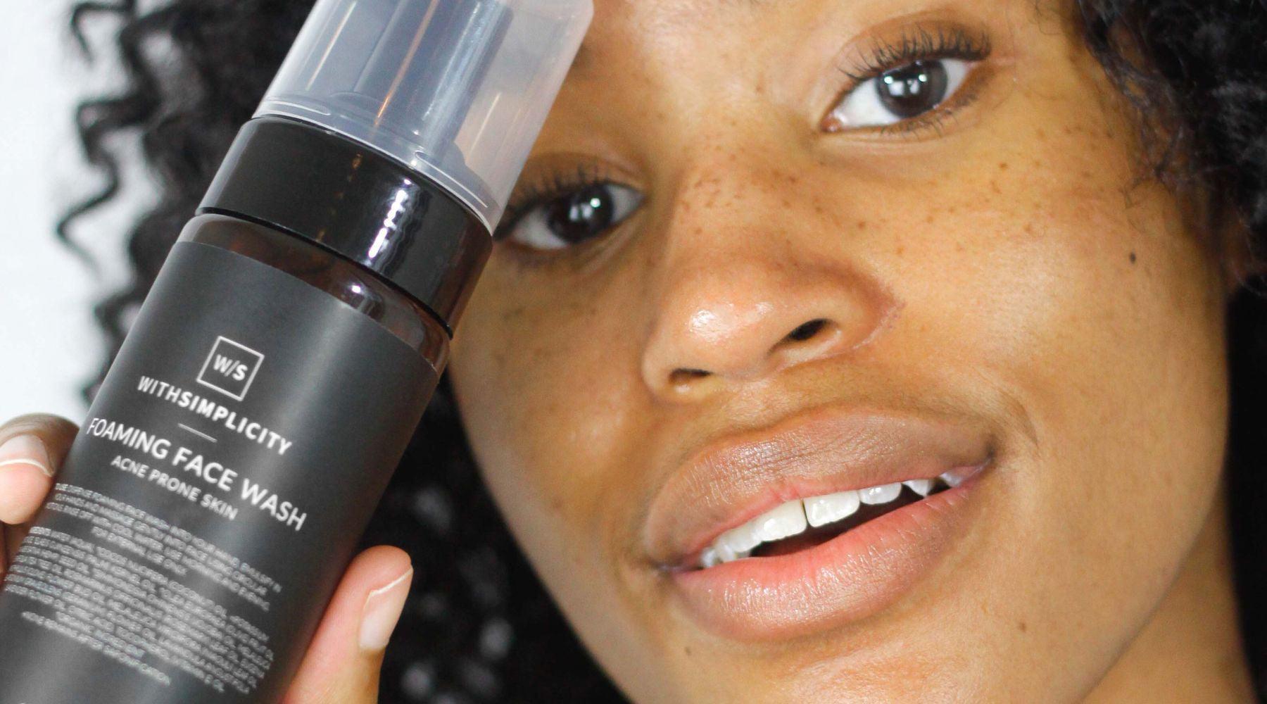 woman holding foaming face wash