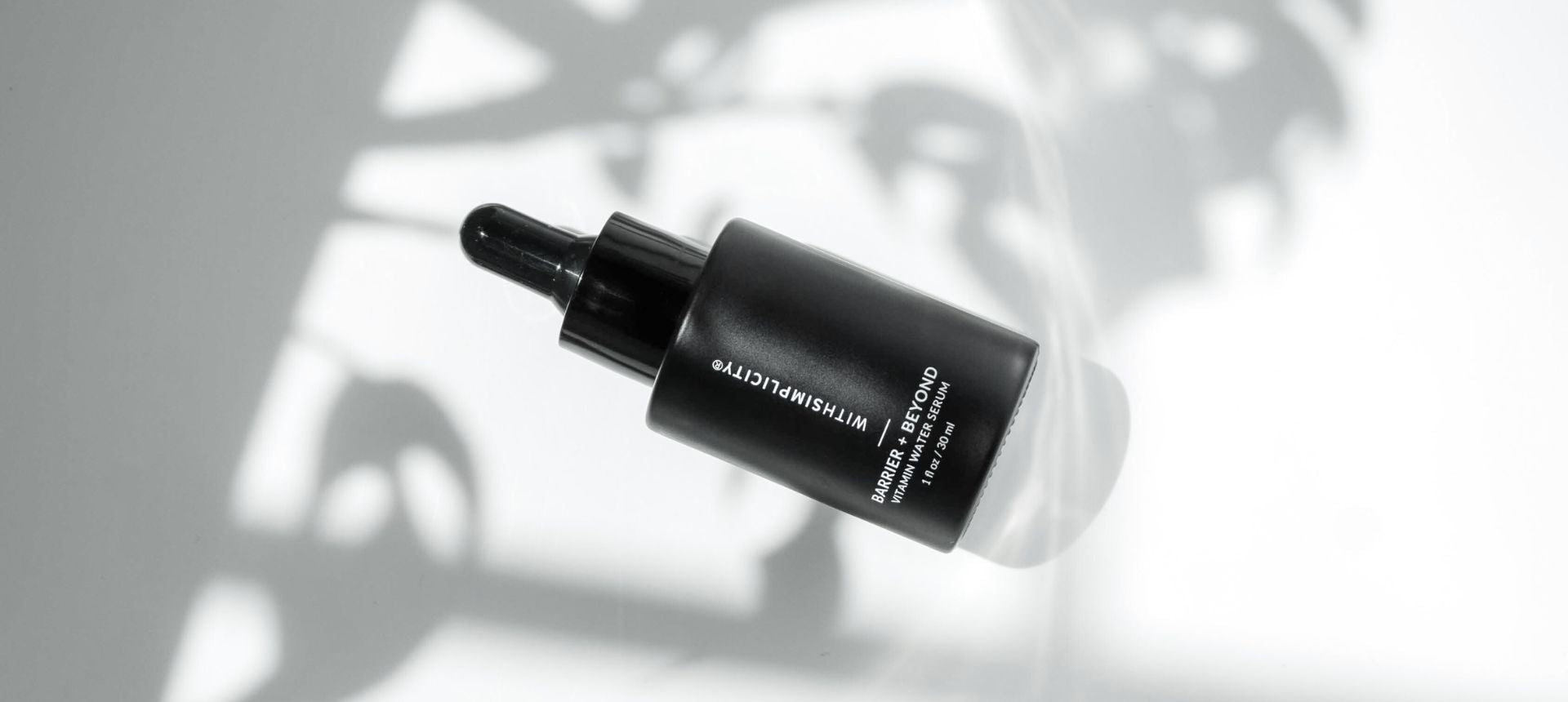 bottle of withSimplicity barrier and beyond vitamin water serum