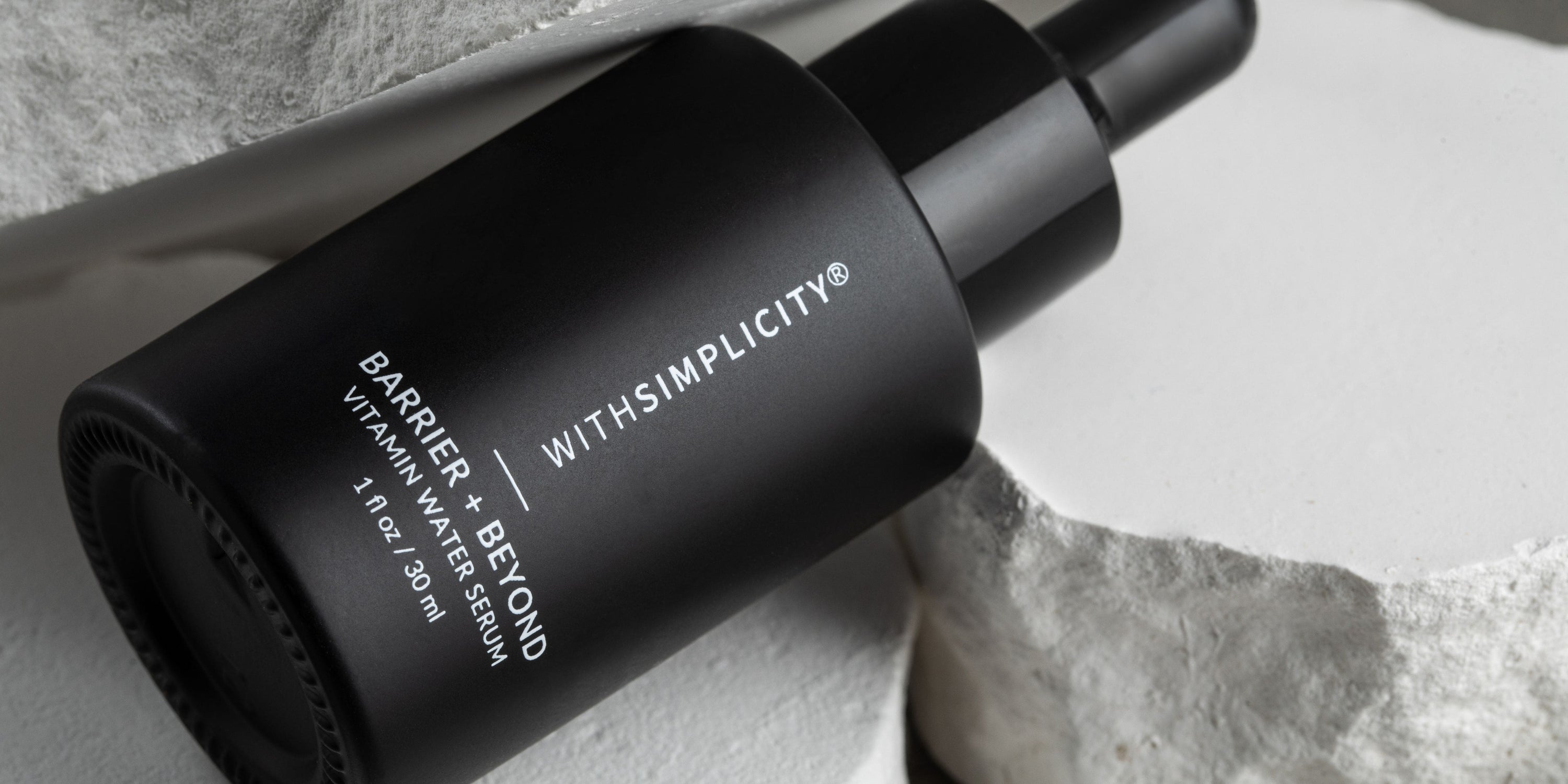 Barrier + Beyond against a rocky background