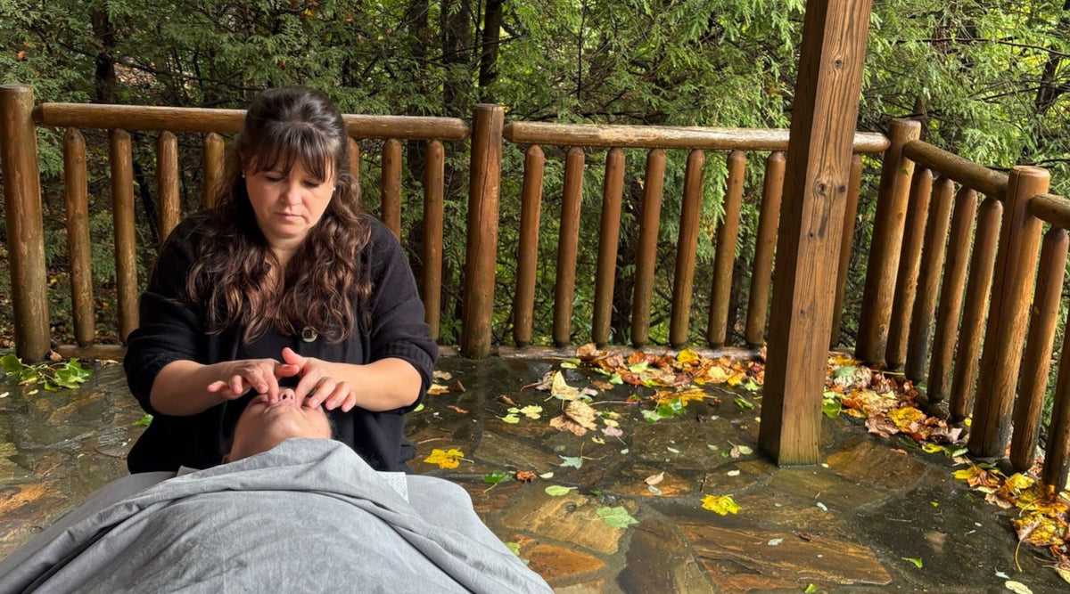 woman receiving a facial in a forest setting