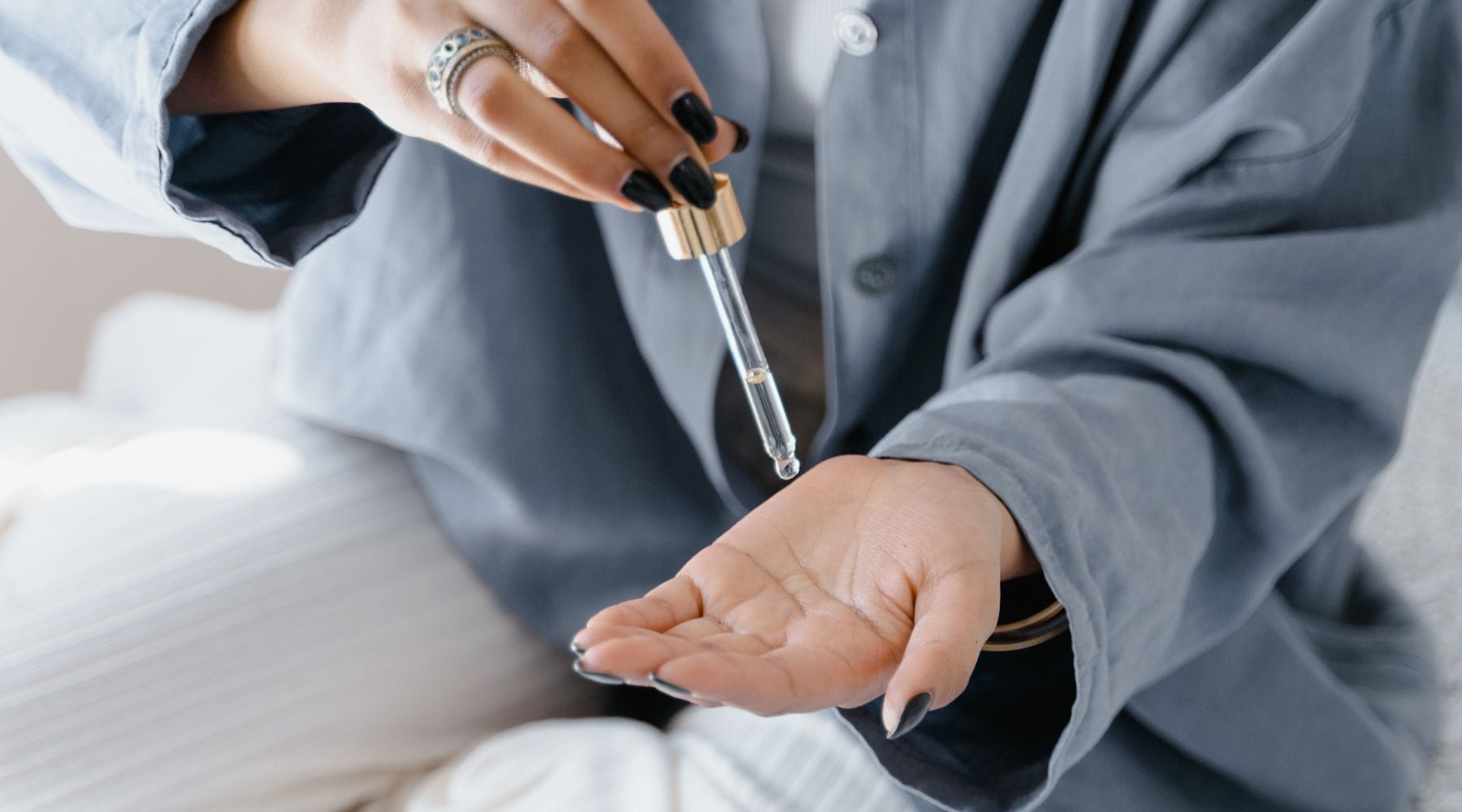 woman applying essential oils to hands