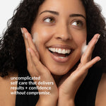 Woman applying cream to her face with a neutral background and the text "uncomplicated self care that delivers results and confidence without compromise."
