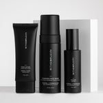 Three black skincare bottles from withSimplicity are arranged on a light gray surface against a white box background. The products include Face Lotion, Foaming Face Wash, and Toner, with white text on the labels.