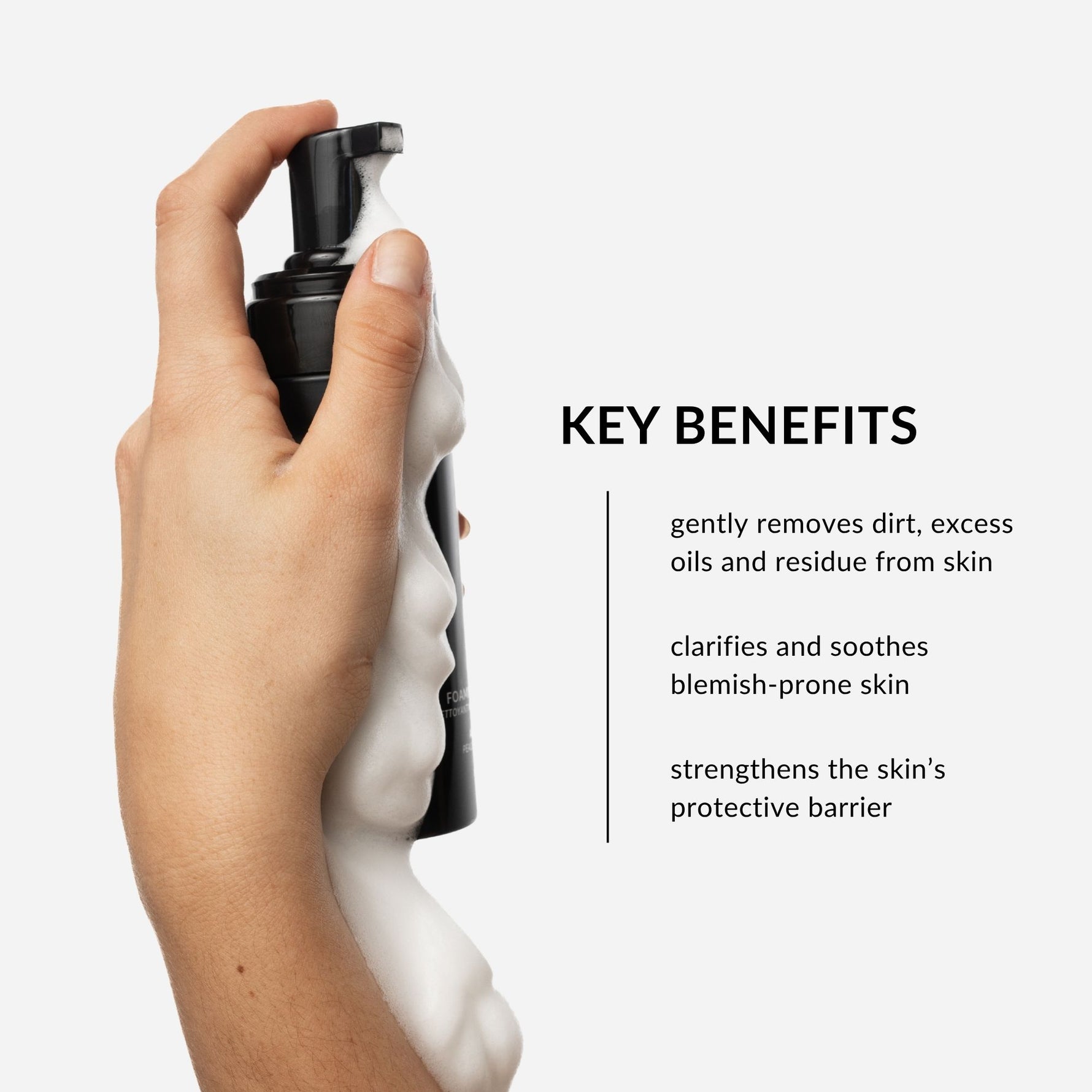 Hand holding a black foaming face wash bottle with white foam, against a light gray background. Text on image lists product benefits including: targets acne-prone skin concerns, gently removes dirt, excess oils, and residue, and finally, strengthens the skin's protective barrier