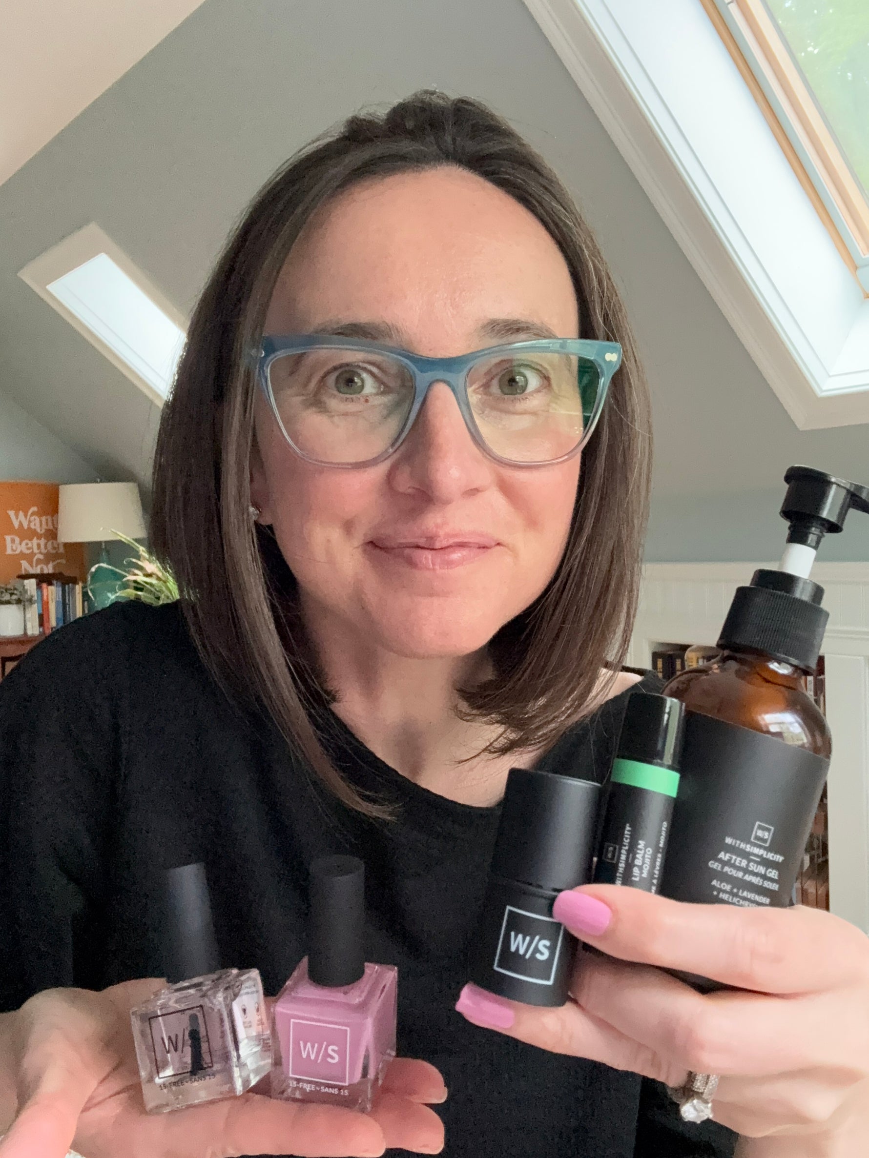woman holding withSimplicity products in room with a window
