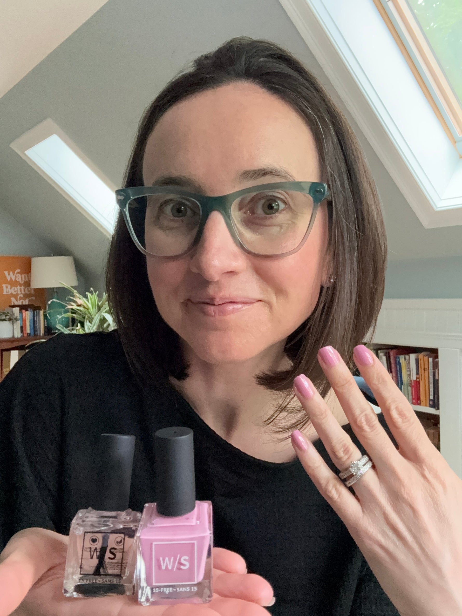 woman holding withSimplicity nail polishes and showing color on nails