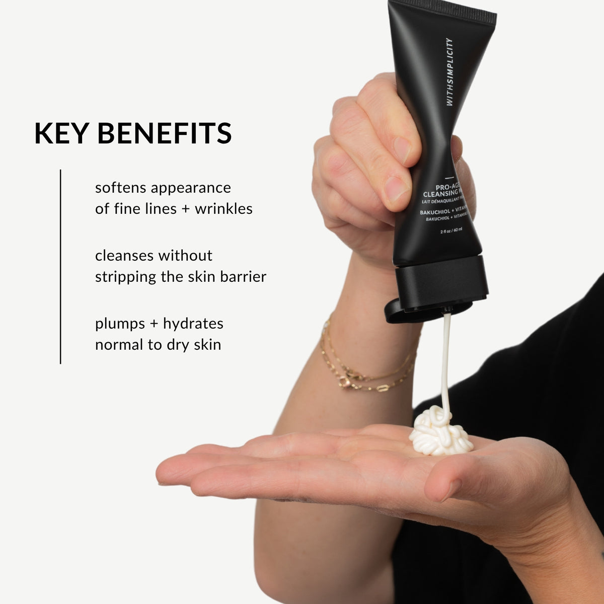 A person squeezes a black tube of withSimplicity Pro-Age Cleanser onto their palm, with text on the left listing key benefits of the cleanser