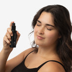 Woman holding withSimplicity Acne Prone Toner with a neutral background