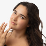 woman applying blemish drops spot treatment to face