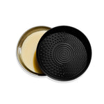 up close of withSimplicity brush cleansing soap bar in tin with black brush cleaning mat