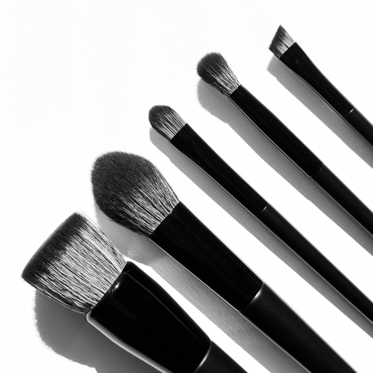five withSimplicity makeup brushes up close against a white background