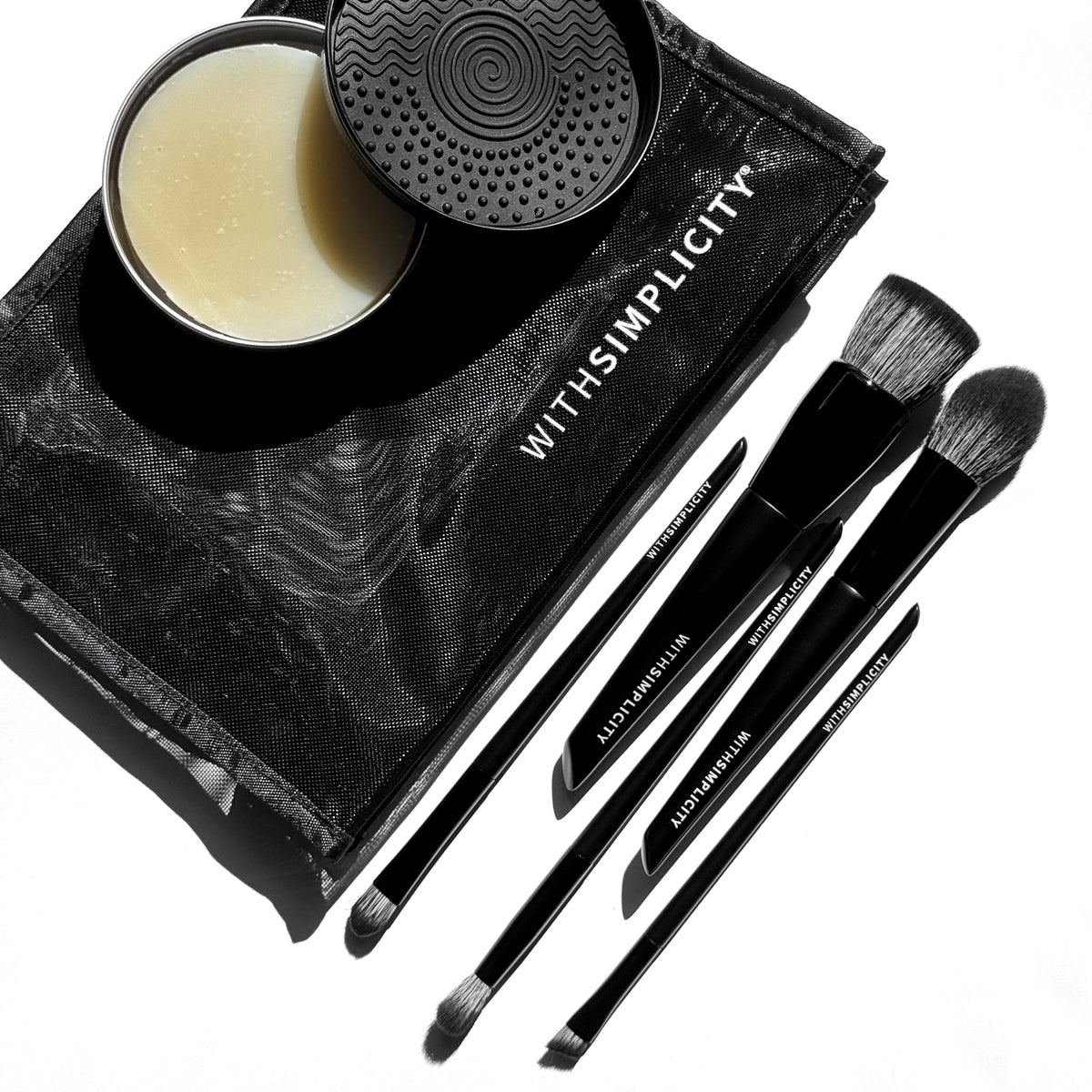 withSimplicity mesh cosmetic bag with five black makeup brushes and a brush cleansing balm on a white background