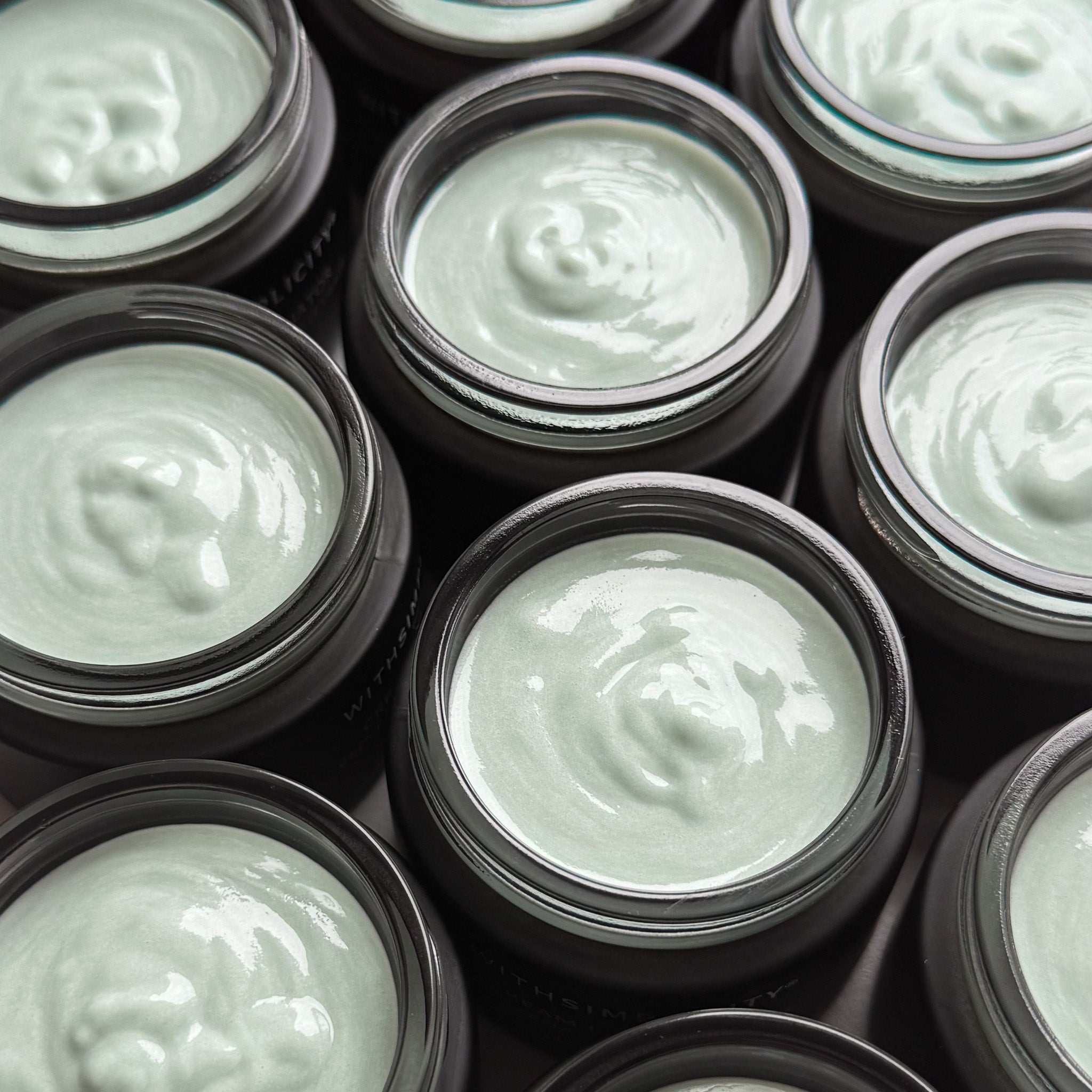 Close up of withSimplicity Cream Exfoliator with Glycolic Acid jars