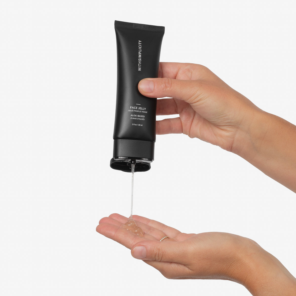 withSimplicity Face Jelly tube being squeezed into palm of hand against light gray background