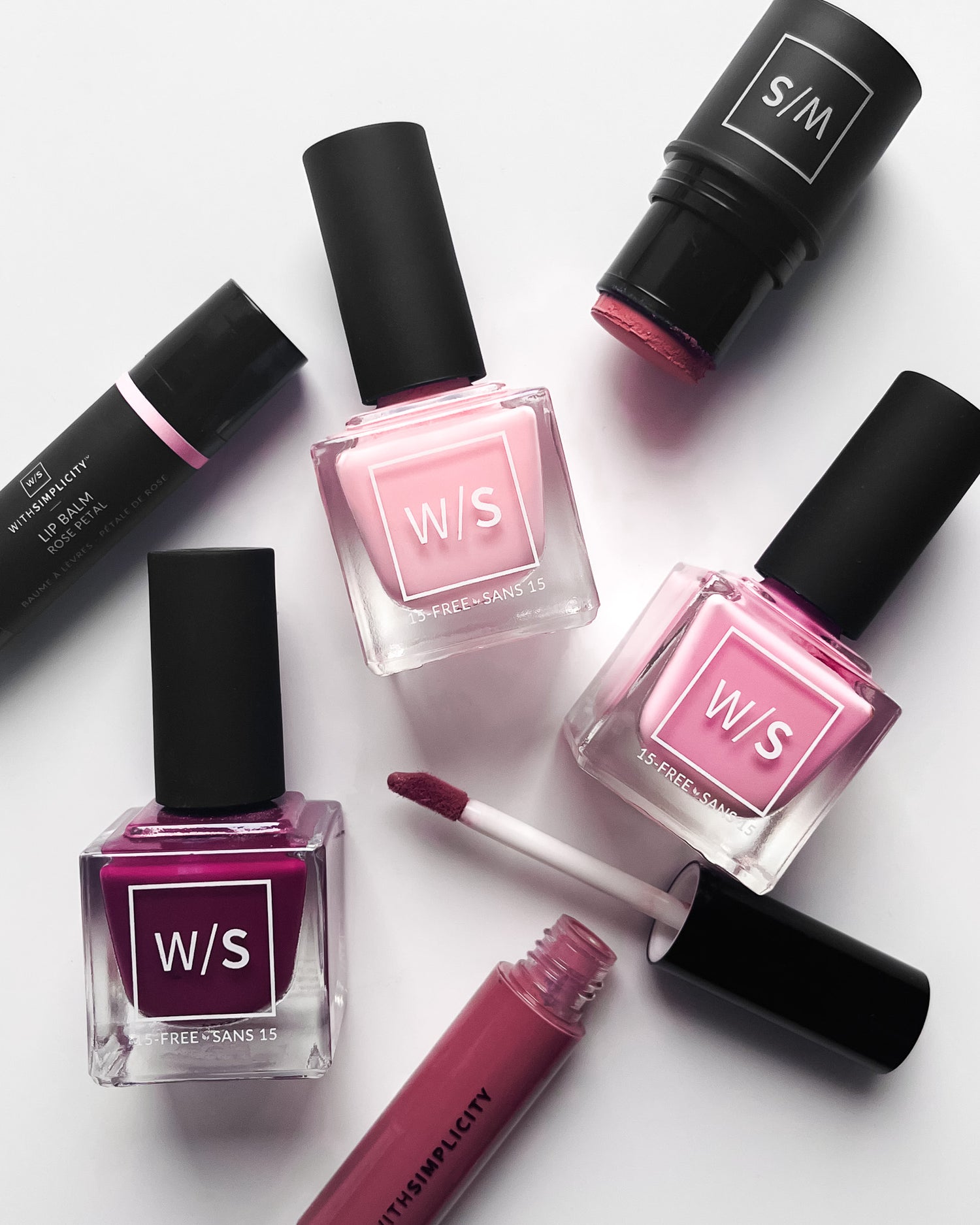 withSimplicity cosmetic and nail polish products, all pink in color, on white background