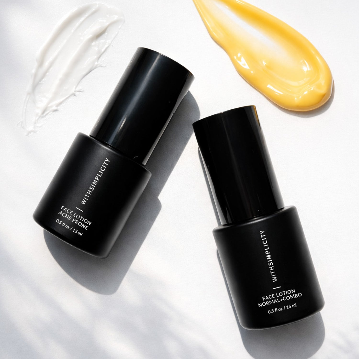 withSimplicity Face Lotion Acne Prone and Face Lotion Normal Mini Bottles on white background with face lotion swatches