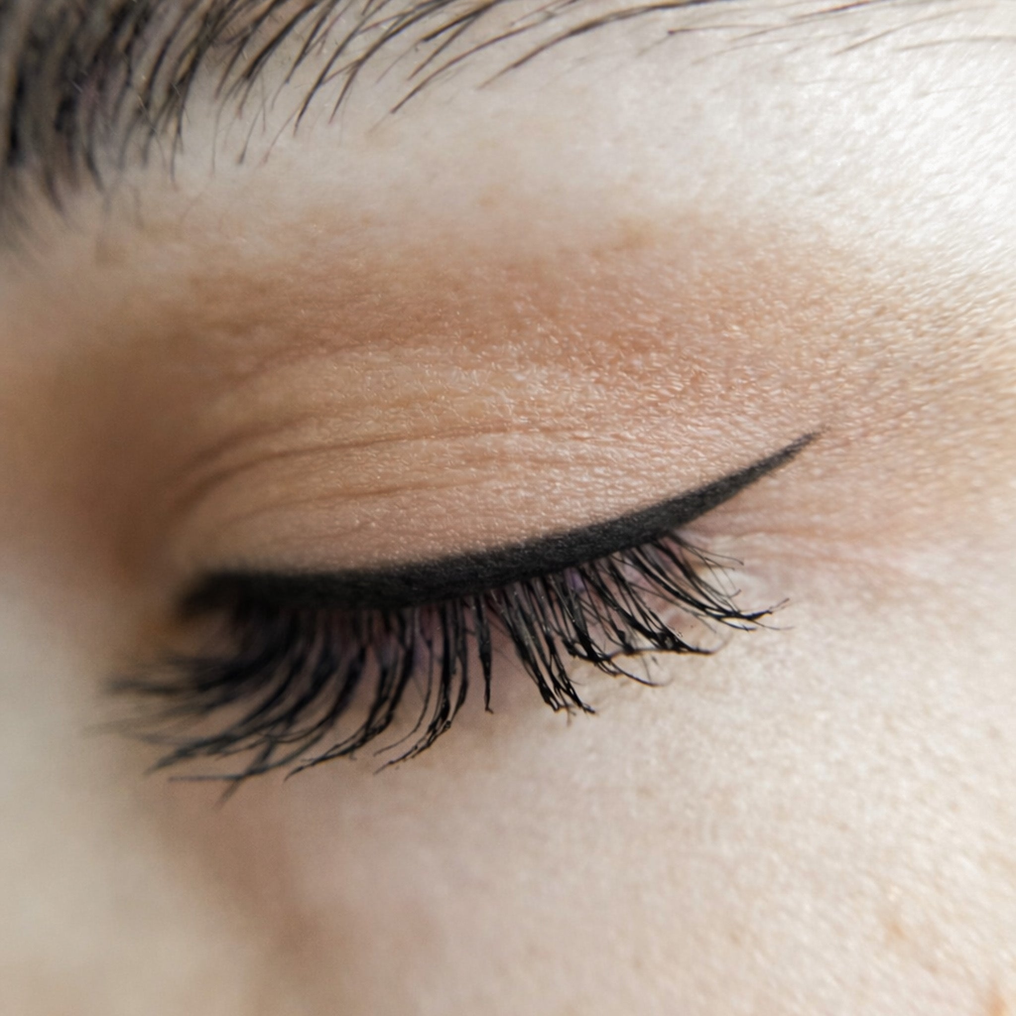 Close-up of an eye with black eyeliner and black mascara applied