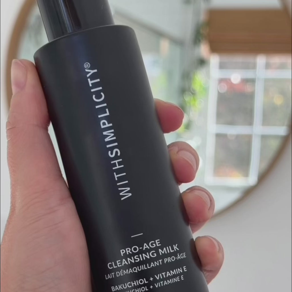 woman using multiple withSimplicity skincare products in her bathroom in a routine-style video.