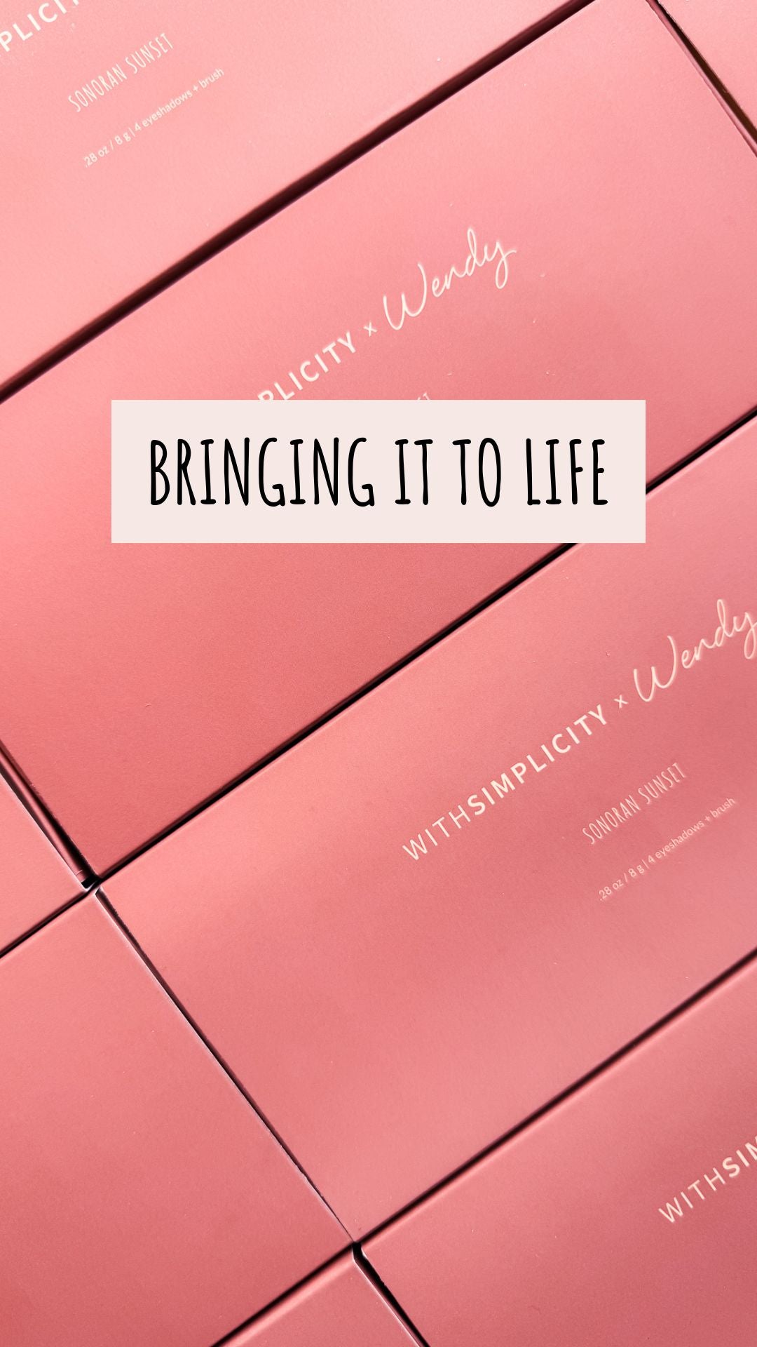 Behind-the-scenes video of a photoshoot day: a team packing rose-pink palette boxes in an office, a stylist curling a woman's hair, three women smiling for a street selfie, a woman applying eyeshadow in a studio with white backdrop and softbox lighting, ending with two women hugging and laughing.