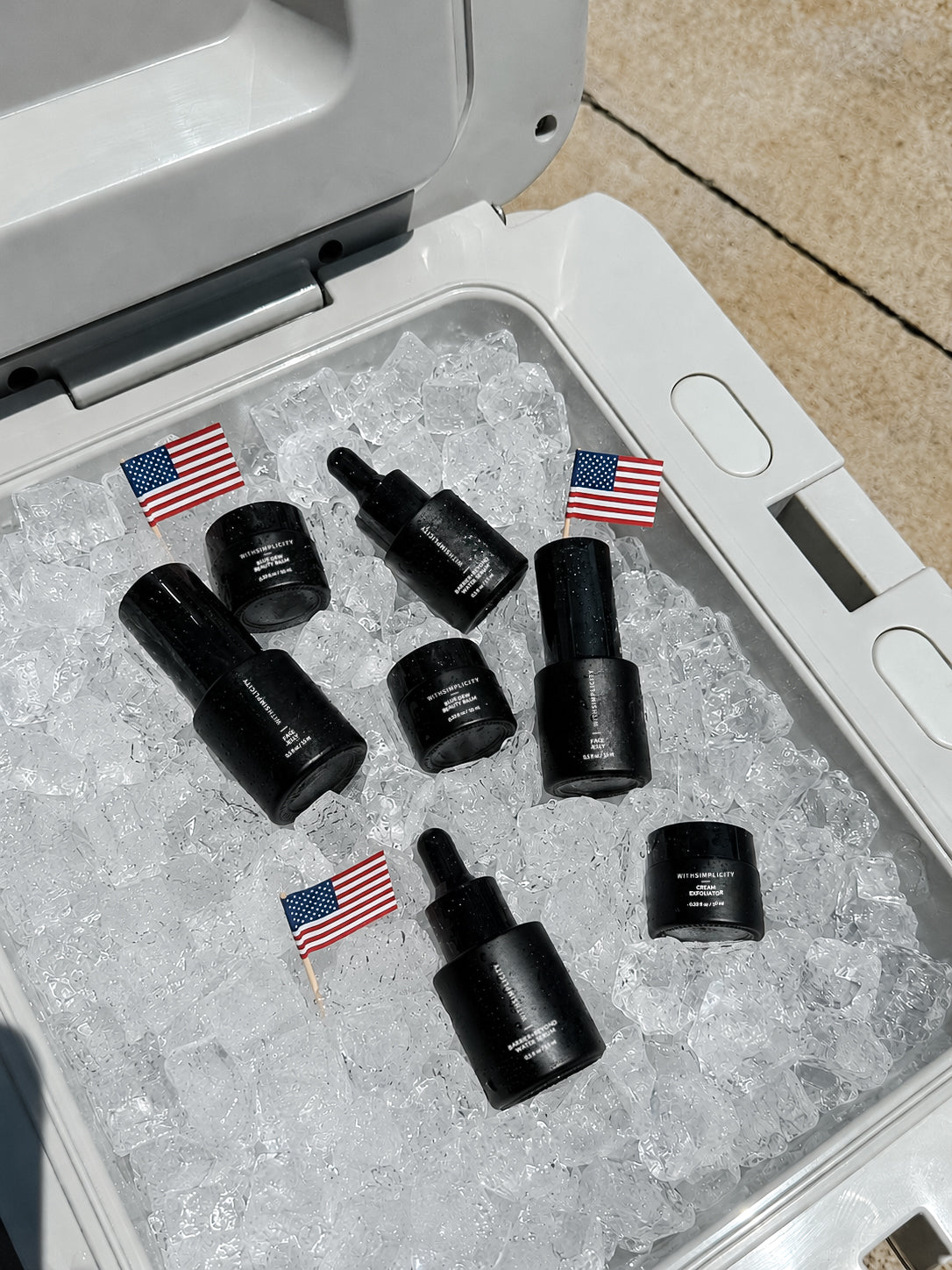 withSimplicity mini skincare bottles in cooler with ice and american flags