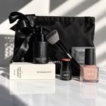withSimplicity skincare, make up and nail polish with a black cosmetic pouch with a black ribbon against a white background