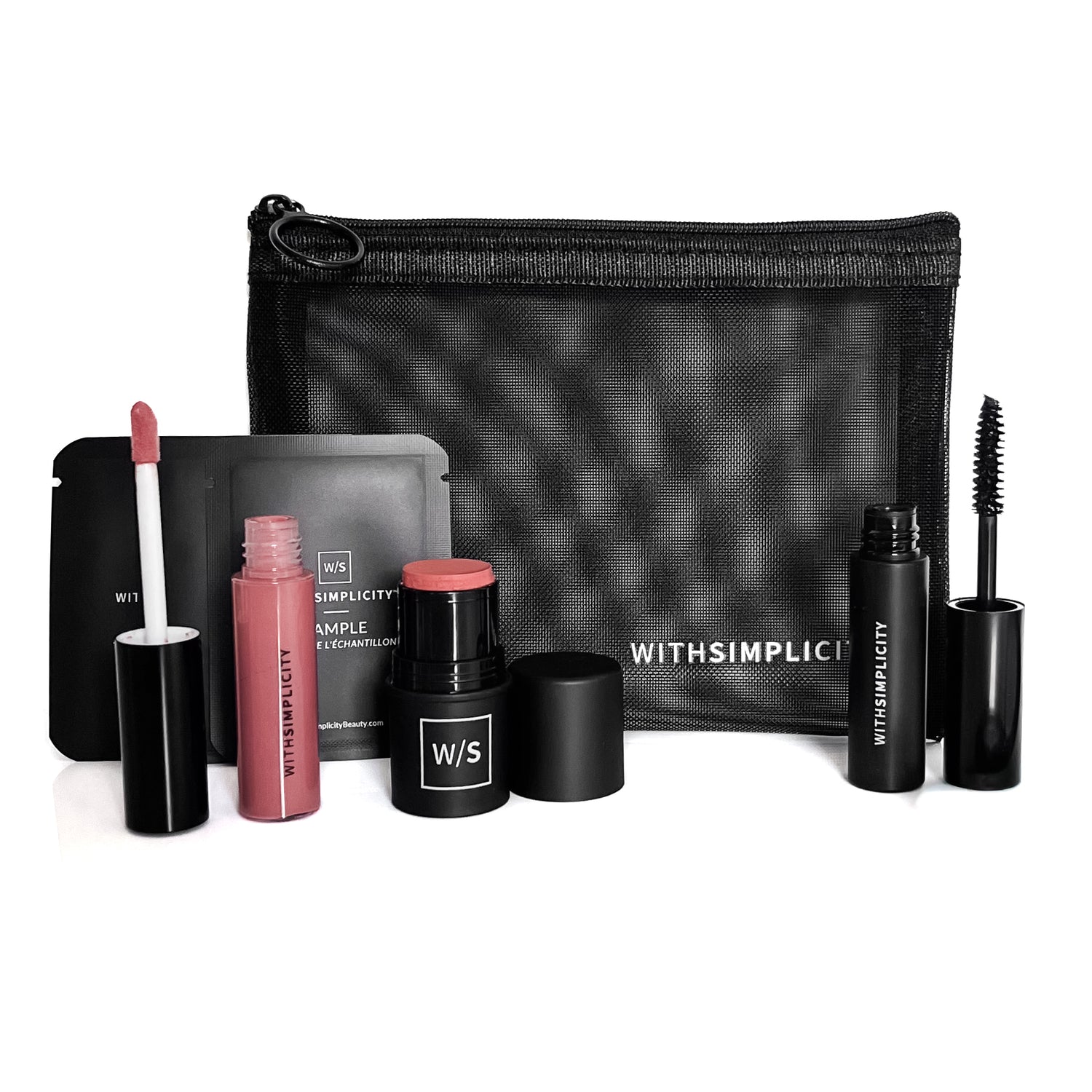 Makeup set with various products and a black pouch on a white background