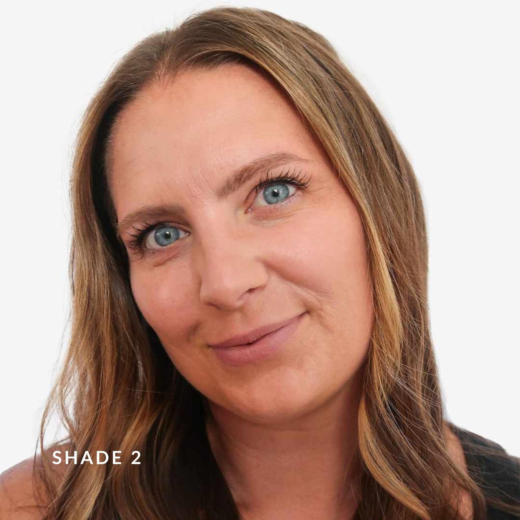 Woman with blonde hair and blue eyes on a white background. Text says Shade 2