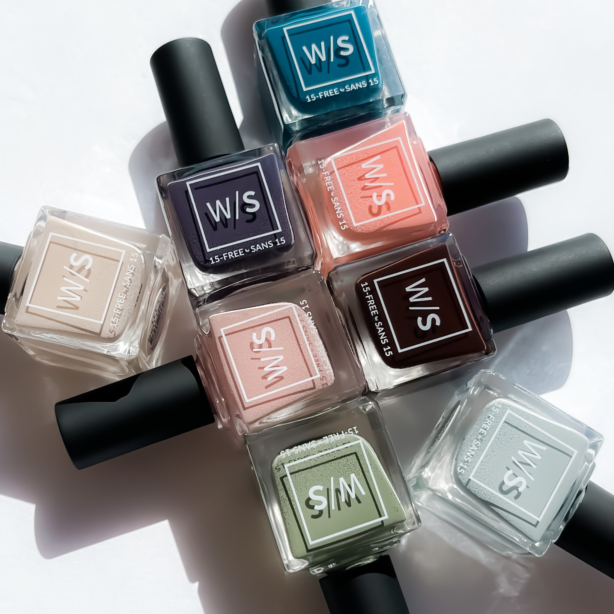 Collection of withSimplicity 15-free nail polish bottles on a light background